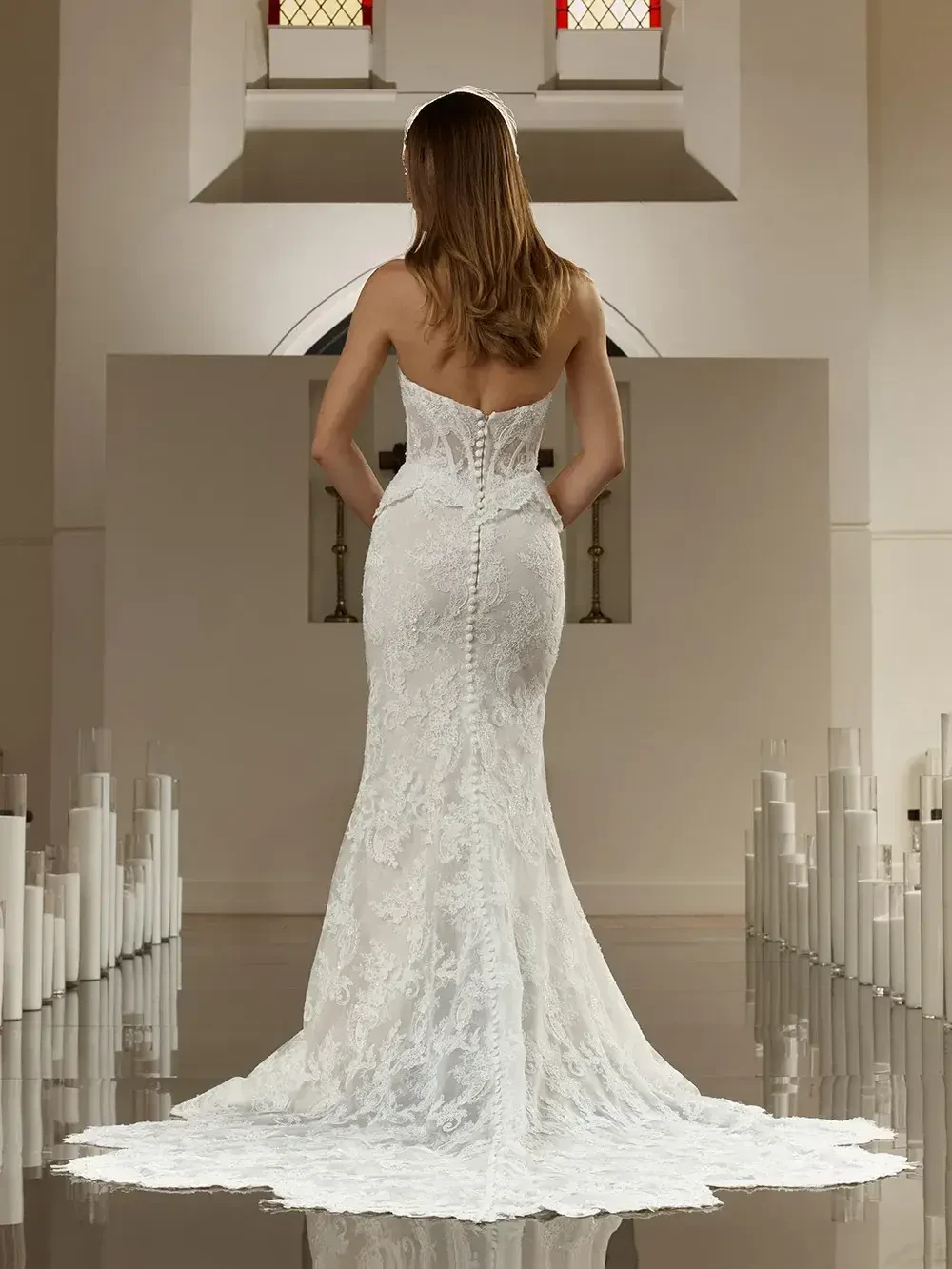model is wearing a strapless fit and flare wedding gown