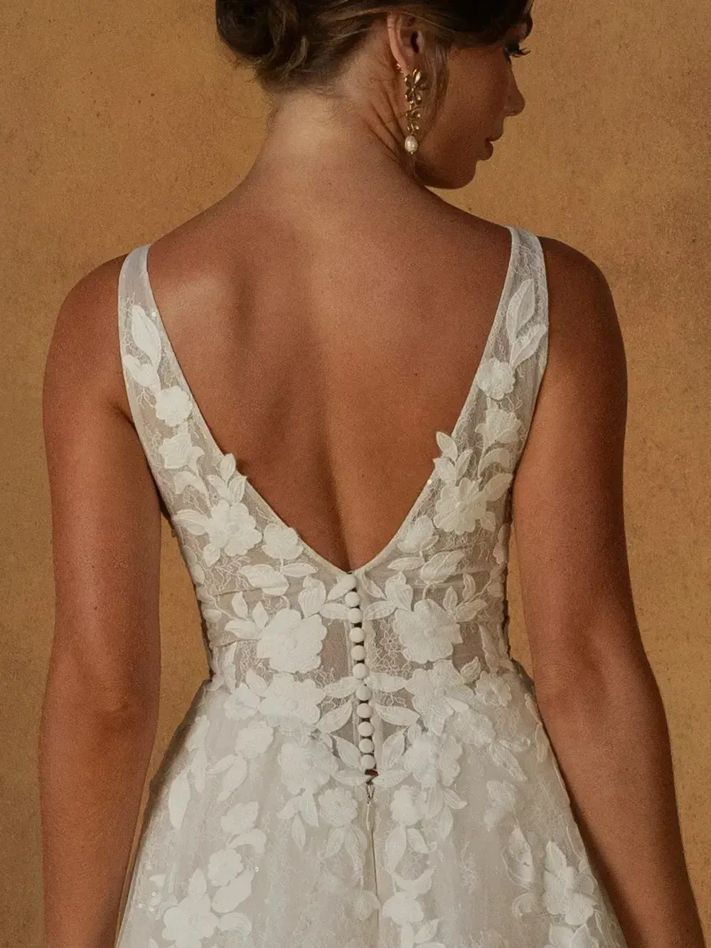 model is wearing a sleeveless a-line bridal gown