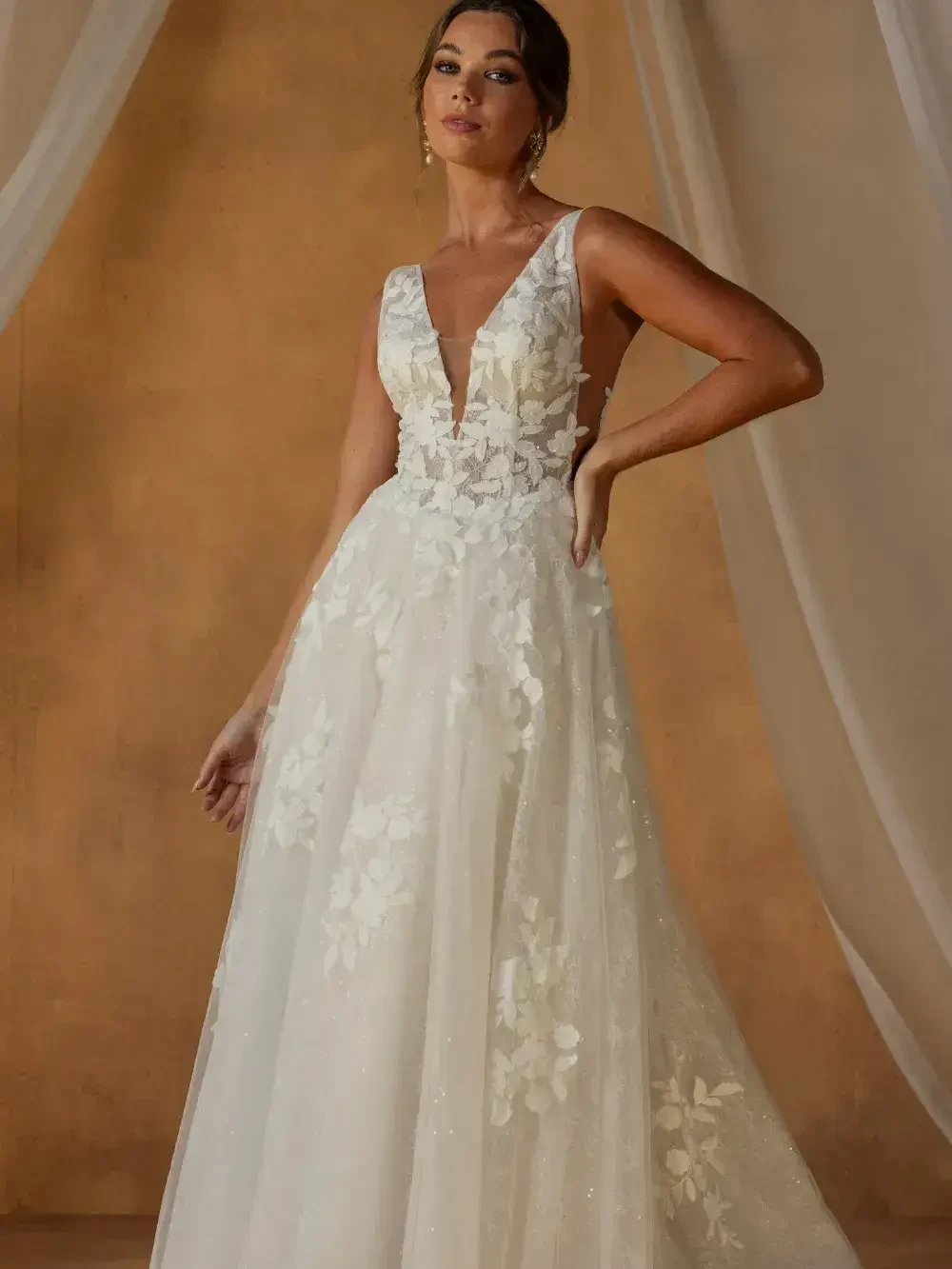 model is wearing a sleeveless a-line bridal gown