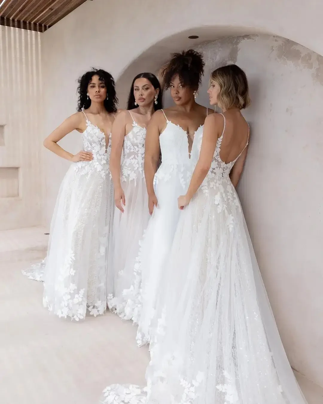 Models wearing multiple sizes of the same wedding dress